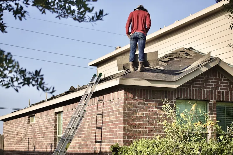 Professional roofer working on a residential roof in Jefferson Valley